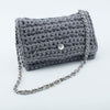 

Ribbon Clutch-Handtasche
1