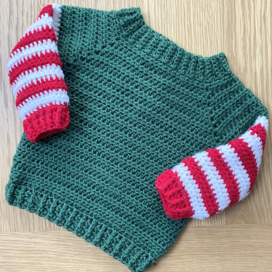 

Baby Elf - Weihnachtspullover und - Mütze
5